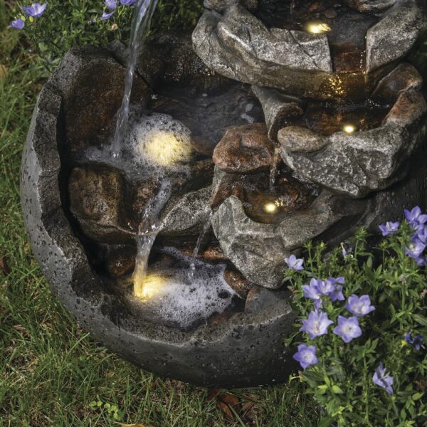 Enchanted Garden 23.62 inches Tiered Riverview Park Outdoor Water Fountain This spherical Riverview Park Water Fountain will add a beautiful dramatic element to your garden. The stepping stones of the waterfall portion of the fountain beckon you to come closer to absorb the peaceful sound it makes. Two pools of water are lit with LED lights, adding a warm glow to your fountain in a shady spot in your yard, or throughout the evening. Crafted from polyresin and fiberglass, it will last many years if stored safe from frost during the harshest Winter weather. Material Composite Flow Rate 290.62 gallon per hour Includes  Warm white LED lights, Pump Capacity  2.95 gallon (US) Number of Tiers  7 Color/Finish  Beige Dimensions  23.62 in H x 20.67 in W x 19.69 in D Weight  22 pounds Crafted of polyresin and fiberglass Includes 5 warm white LED lights Includes a 6 ft. power cord for the water pump For outside use only